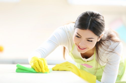 Cleaner wearing PPE while working safely
